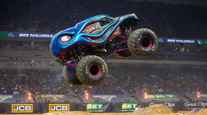 A Fortnite character standing beside a giant Monster Truck with the Monster Jam logo.