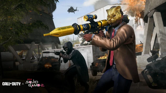 Promotional image for the Squid Game Call of Duty event, featuring a character in a golden mask and suit wielding a golden RPG, with another character in a black stealth suit engaging in combat in a war-torn environment with explosions and a helicopter overhead.