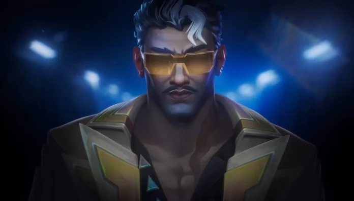 A striking promotional image of Tejo, the new agent in Valorant, featuring a close-up of his face. He sports a confident expression and is adorned with futuristic golden sunglasses and a stylish, sleek jacket. The dramatic lighting accentuates his sharp features and the detailed design of his attire, hinting at his unique abilities and the high-tech, action-packed nature of the game.